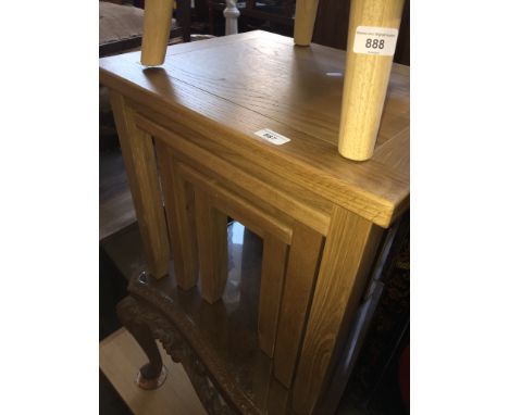 A modern light oak nest of tablesDimensions of largest: height 50cm, width 54cm, depth 42cm.