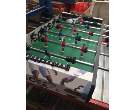 A soccer table game and two pairs of roller skates.Condition:- General wear through age and use, One ball included and no sig