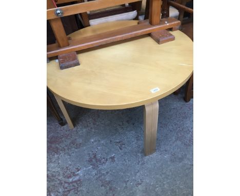 A light wood round coffee table 