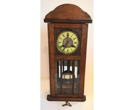 Edwardian miniature American oak cased wall clock compete with pendulum; 63cm ht