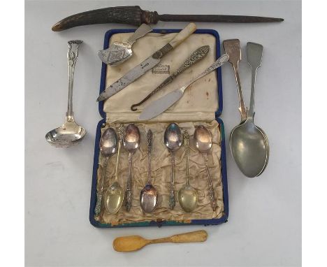 Collection of silver-plate items including a sifter spoon, tea caddy spoon, boxed set Apostle Spoons, carving knife and fork,