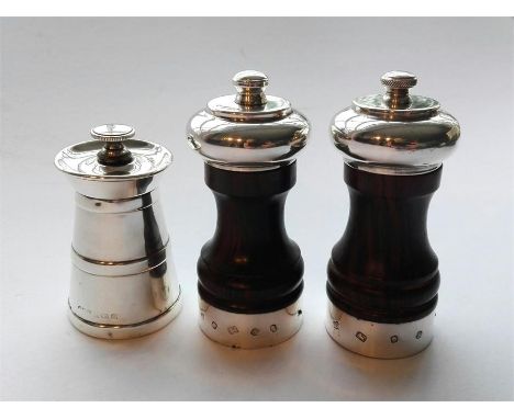 A pair of silver mounted wooden salt & pepper grinders London 1979 together with a solid silver pepper grinder 1929