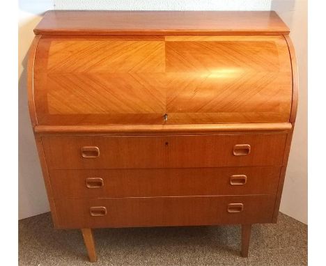 An MCM Danish cylinder roll-top desk, circa 1960, teak veneer, sliding top, the roll-top quad cut mirrored veneer, key to top