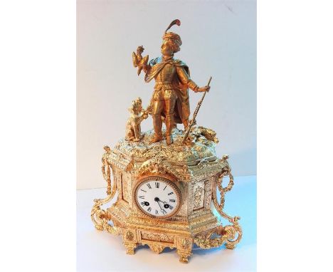 19th Century French gilt chiming mantle clock, figurine of a hunter and dog to the top