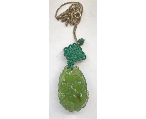 A Jade pendant carved with flowers, 4cm h