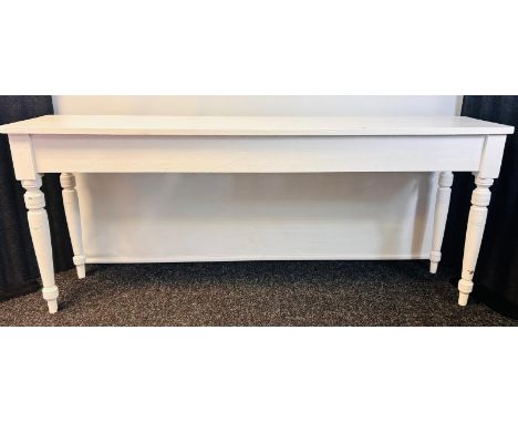 White painted pine console table, raised on turned tapered legs [78.5x193x43cm]