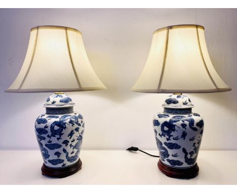 TABLE LAMPS, 60cm H x 40cm diam., a pair, Chinese Export style blue and white ceramic, with  cream shades. (2) 