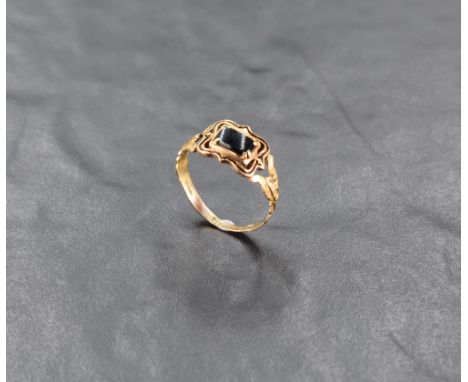 A William IV 18ct gold gent's mourning ring having black panel and enamelled decoration to shaped shoulders on 18ct gold loop