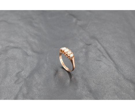 A five stone graduated opal ring in a clawed gallery mount on a 9ct rose gold loop, size O/P &amp; approx 1.8g (chip to one o