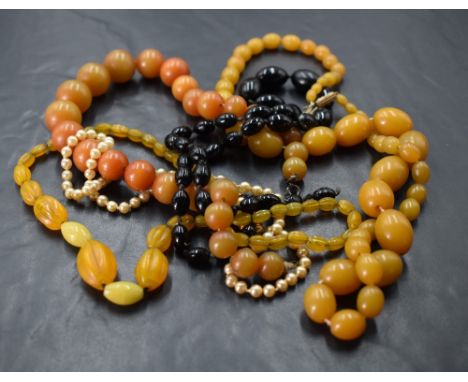 Five strings of beads including amber style, simulated pearl with gold clasp and jet style