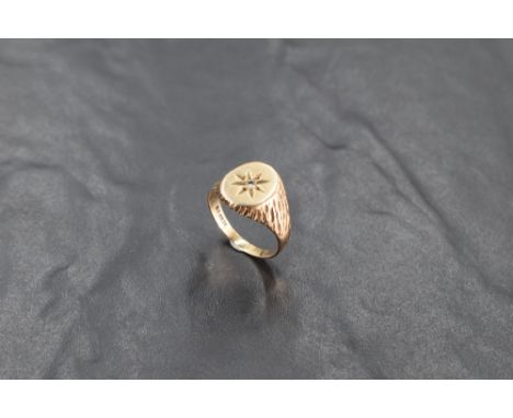 A gent's 9ct gold signet ring with inset diamond in star mount to barke effect shoulders, size Q &amp; 5.8g