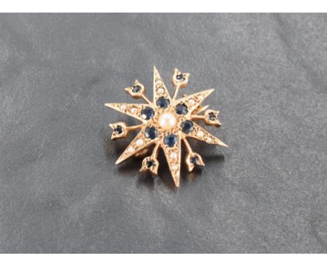 A 9ct gold sapphire and seed pearl set star brooch, marked 375 to reverse, 2.5cm, 3.5grams