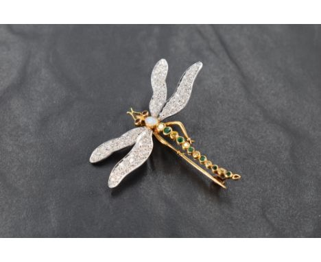 An 18ct white and yellow gold dragonfly brooch, the wings pave-set with small diamond brilliants the body inset with opal, ru