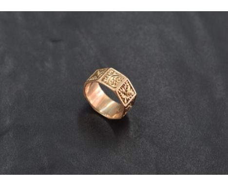 A 9ct gold wedding band, of octagonal form, engraved with foliate detail, marked 375, ring size I, 3.4grams