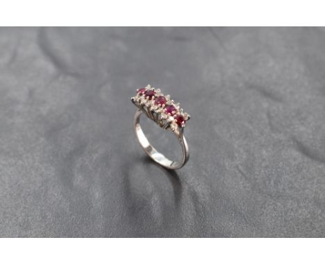 A ruby and diamond triple row ring having central row of five diamonds within a border of diamond chips, size O and approx 4.