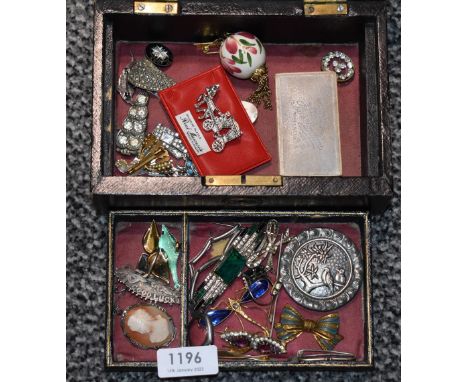 A vintage black leather bound travel jewellery box containing a selection of costume jewellery brooches, and silver including