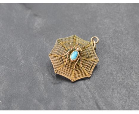 A 9ct gold turquoise and seed pearl set spider and web pendant, marked 9ct to suspension, 2cm, 1.2grams