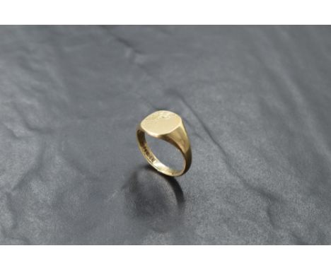 A gent's 9ct gold signet ring having engraved decoration to plain panel, size W/X &amp; approx 7.4g