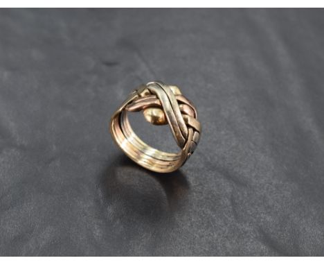 A 9ct tri-colour gold puzzle ring, of Celtic knot design, marked 375 to shank, ring size X, 13.5grams