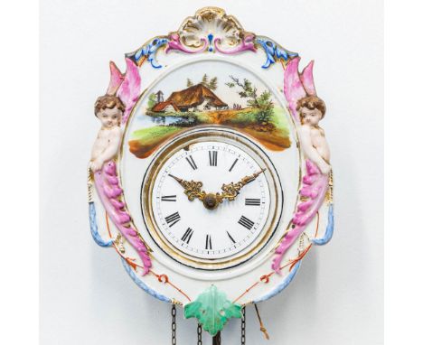A 'Jockele' clock made of porcelain with putti and handpainted decor, Germany, 19th century. (10 x 20 x 26 cm)