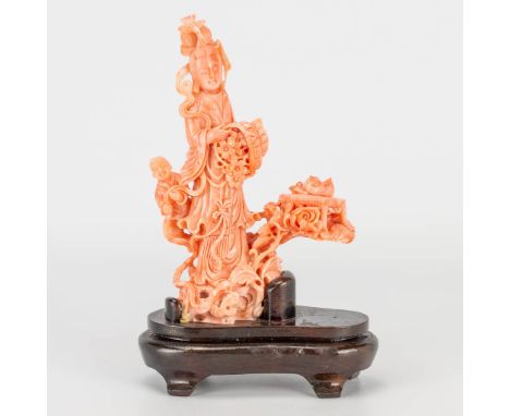 A Chinese pink coral sculptured statue of a lady with child, around 1980. 282g without stand. Size without the stand. (5 x 10