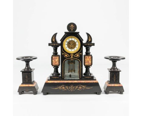A 3 piece garniture clock made of black marble with engravings. 19th century. (13 x 42 x 51 cm)