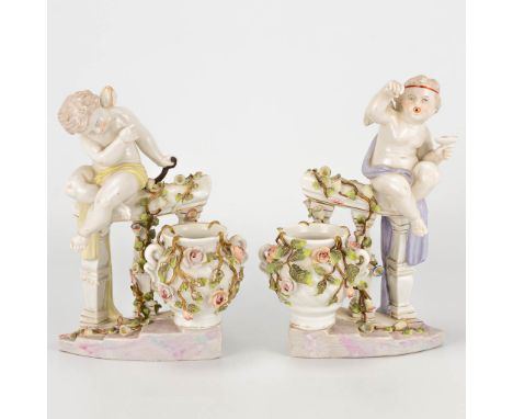 A pair of porcelain figurines of angels on a handrail with flowers, marked Sitzendorf porcelain and made in Germany. The firs