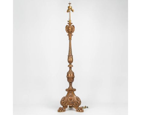 A large lamp base made of sculptured wood, standing on claw feet with sculptured children's faces. First half of the 20th cen