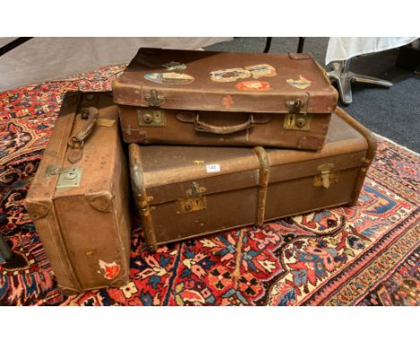 Two vintage suitcases and cabin trunk.