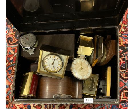 A tin trunk of mixed clocks.