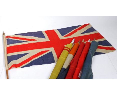 A selection of Early 20th century British and Commonwealth patriotic flags, printed on bunting material, mounted on wooden po