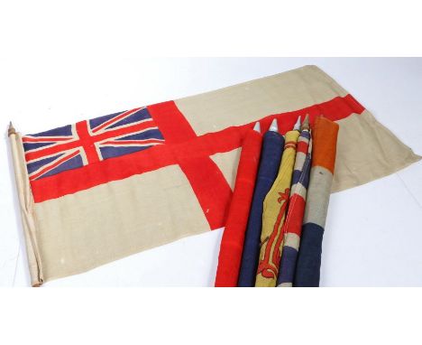 A selection of Early 20th century British and Commonwealth patriotic flags, printed on bunting material, mounted on wooden po