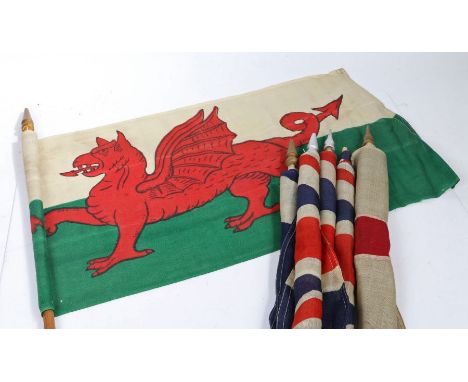 A selection of Early 20th century British patriotic flags, printed on bunting material, mounted on wooden poles with detachab