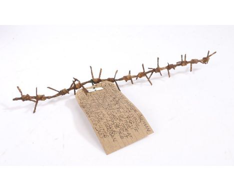 First World War length of barbed wire, label states 'Barbed wire, Imperial German, recovered from High Wood, Somme battlefron
