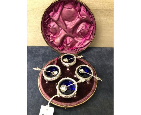 A CASED SET OF FOUR SILVER TRIPOD TUB SALTS AND SPOONS LONDON 1887
