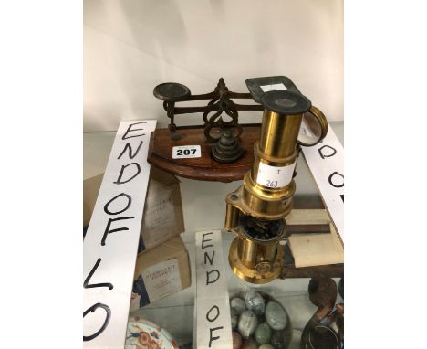 A STUDENTS MICROSCOPE TOGETHER WITH A SET OF LETTER SCALES WITH WEIGHTS