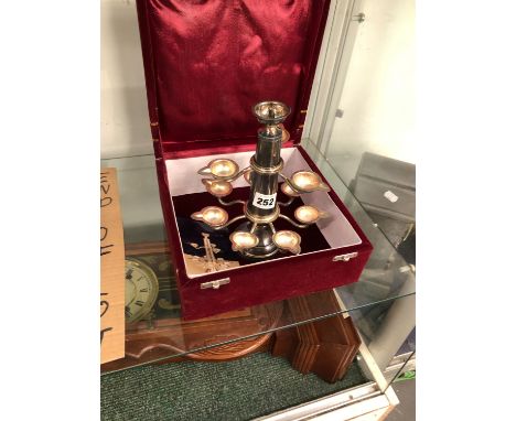 A RED VELVET CASED INDIAN ELECTROPLATE ELEVEN LIGHT OIL LAMP