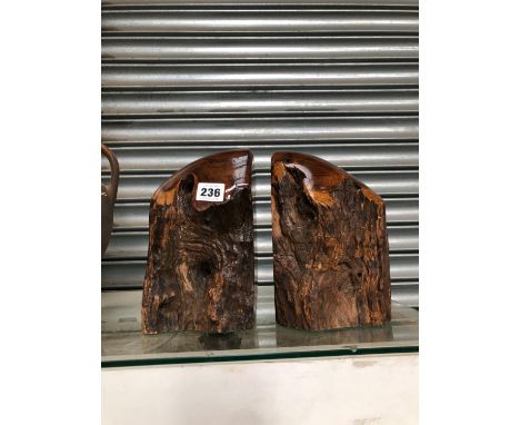 A PAIR OF YEW WOOD TREE TRUNK SECTION BOOKENDS