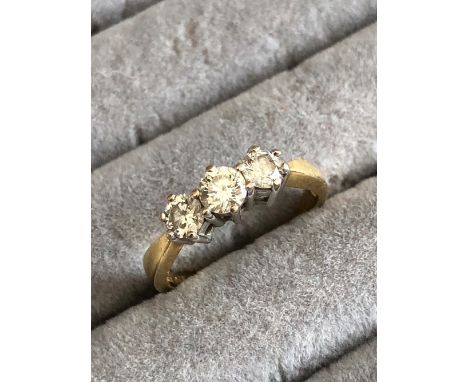 AN 18ct HALLMARKED GOLD THREE STONE DIAMOND RING. DIAMOND WEIGHT AS STATED 0.75cts. FINGER SIZE M. WEIGHT 2.97grms.
