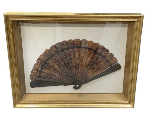 A mid to late 19th century Chinese tortoiseshell folding fan (framed), with label verso for Harrow Arts Ltd and handwritten l