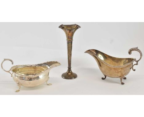 A George V hallmarked silver trumpet vase, Birmingham 1920, height 15cm, (loaded), a George V hallmarked silver sauceboat, Lo