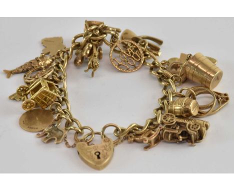 A 9ct yellow gold charm bracelet, with twenty-three assorted charms including car, boots, love heart, articulated fish, keys,