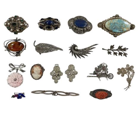 A collection of seventeen silver and other fancy brooches and bracelets etc, some with carved coral, two with lapis lazuli se