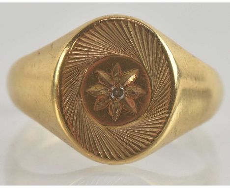 A 9ct gold gentleman's signet ring, the oval table with tiny star set diamond and engine turned swirl decoration, size S, app