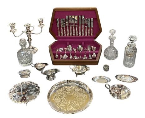A collection of various items of silver plate including a three branch candelabrum, trays, chamberstick, table lighter, three