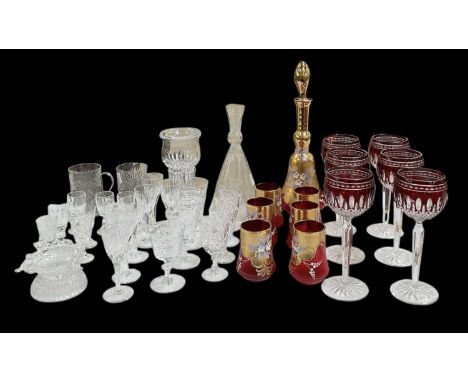 A quantity of assorted cut and crystal glassware, including a set of five Waterford Crystal shot glasses, six cranberry cut g