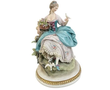 CAPODIMONTE; a modern porcelain figure of a glamorous lady with floral basket and doves, height 28cm.