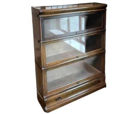 THE GLOBE-WERNICKE CO LTD; an early 20th century oak three-section stacking bookcase, with maker's label and painted label to