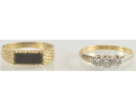 Two gold rings comprising an 18ct three stone diamond set ring, size J, approx 1.6g, and a 9ct gold signet ring with a thin b
