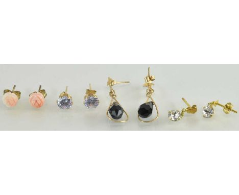 A pair of 9ct yellow gold onyx set earrings, a pair of 9ct yellow gold coral set earrings, a pair of 9ct yellow gold purple s